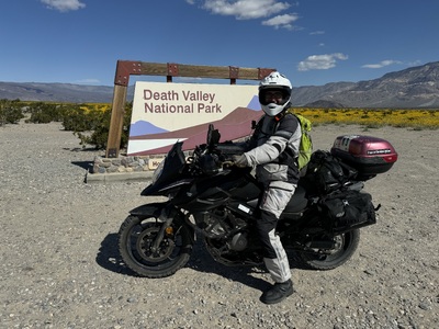 Me on my bike in front of the Death Valley National Park sign