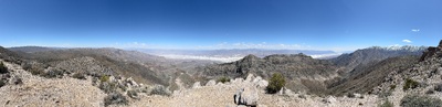 Panoramic view of the desert floor of Death Valley and distant mountains