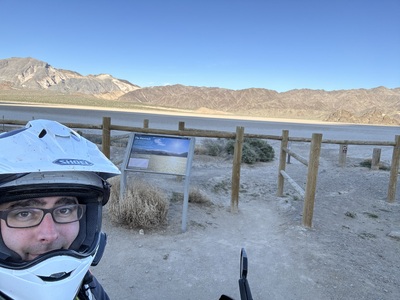 Me at the Racetrack Playa, with an informational sign in background